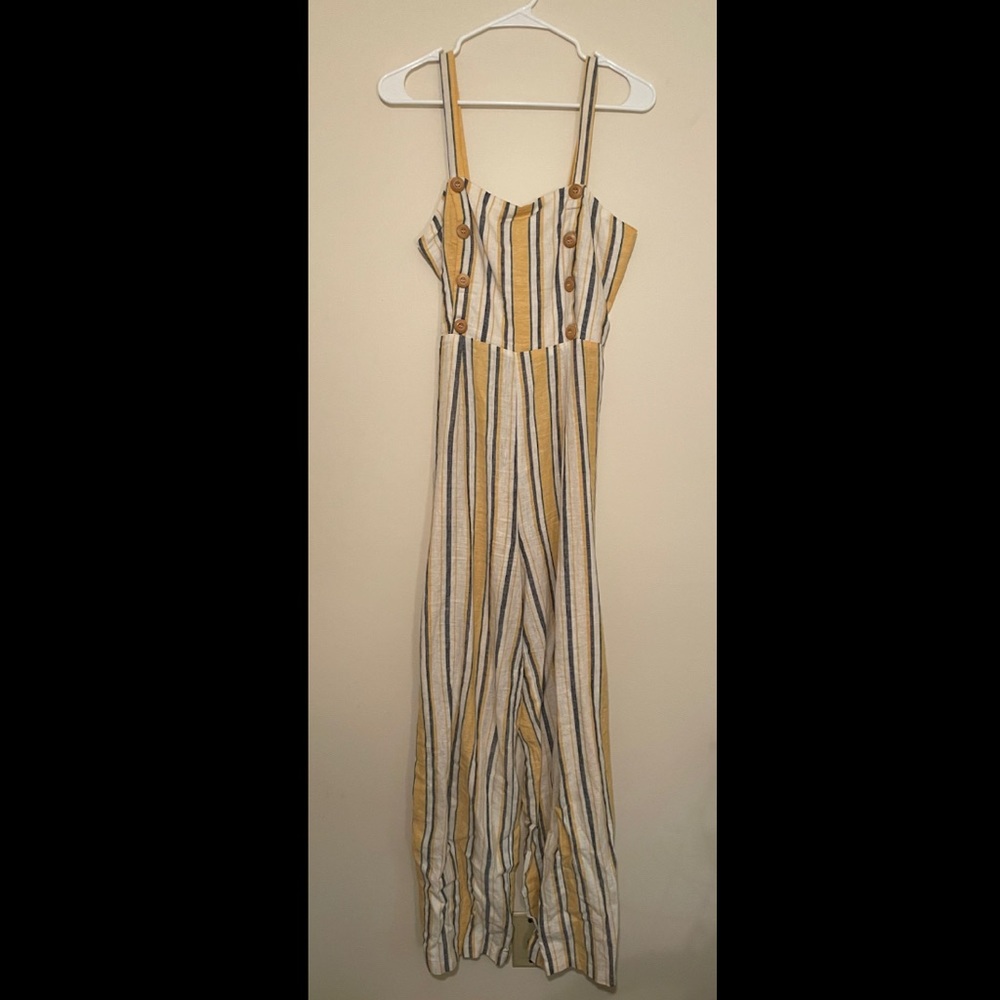 Full length romper with accent buttons, vertical yellow blue and white stripes.